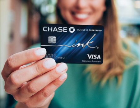A woman holding a Chase credit card